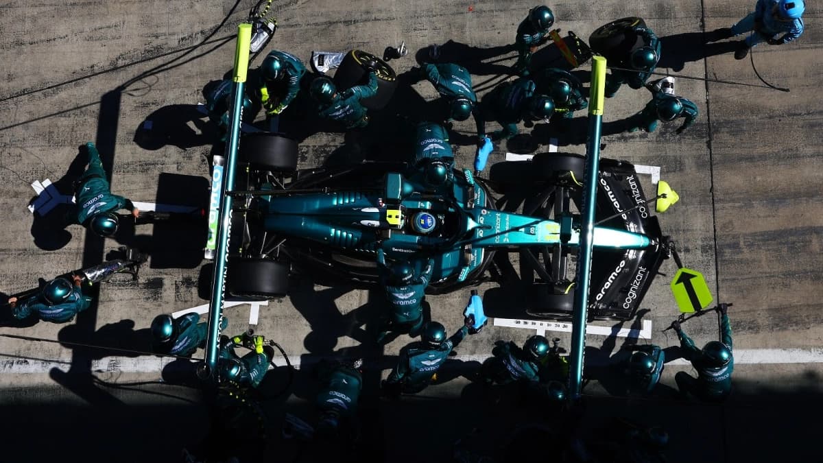 Aston Martin F1 pit crew in action, showcasing the speed and precision of an optimized pit stop powered by Arm technology.