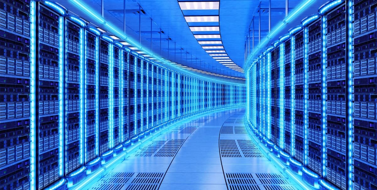 A modern data center rack with servers featuring Arm-based processors, illustrating the converged AI data center architecture.