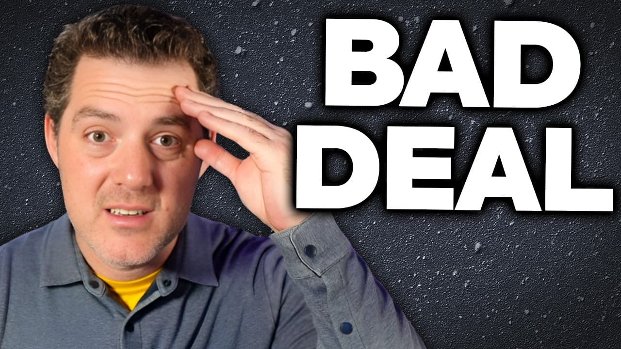 Image of a young man with dark curly hair, wearing a black hoodie and a silver chain, looking directly at the camera.